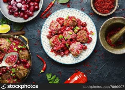 Arabic food lamb kufta spiced with saffron.Appetizing lamb meatballs. Syrian kyufta with cherry