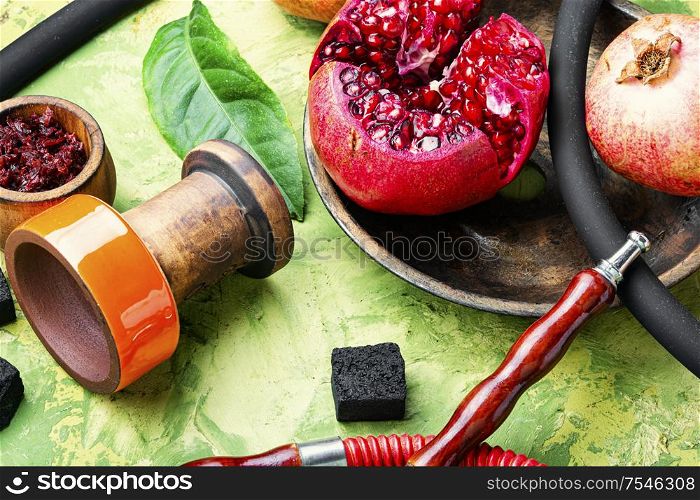 Arabic smoking hookah.Pomegranate flavor hookah.Fruit tobacco shisha. Pomegranate flavor hookah