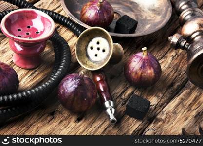 Arabic smoking hookah with figs. Exotic smoked shisha with tobacco with a taste of fig fruit