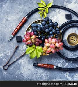 Arabic smoking hookah with grapes. aroma smoked shisha with tobacco with taste of grapes