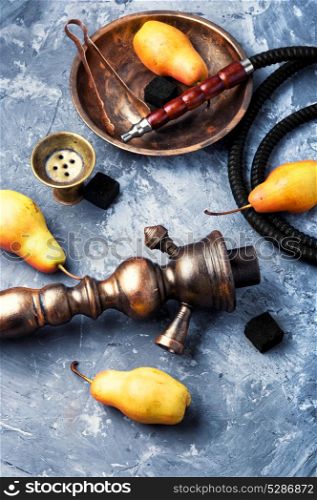 Arabic smoking hookah with pear. hookah with a tobacco aroma of an autumn pear