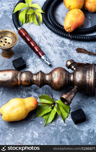 Arabic smoking hookah with pear. oriental hookah with tobacco aroma of an autumn pear