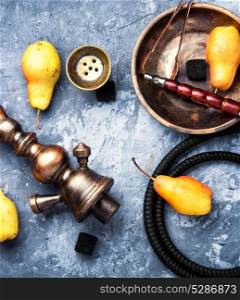 Arabic smoking hookah with pear. oriental hookah with tobacco aroma of an autumn pear
