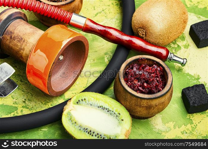 Arabic smoking hookah with taste of kiwi.Fruit shisha tobacco. Tobacco with taste of kiwi.Oriental hooka. Oriental hookah with kiwi fruit