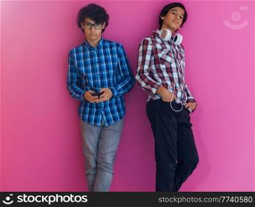Arabic teenagers group portrait against a pink wall. High quality photo. Arabic teenagers group portrait against pink wall