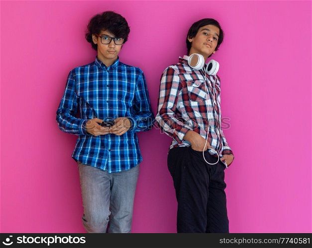 Arabic teenagers group portrait against a pink wall. High quality photo. Arabic teenagers group portrait against pink wall 