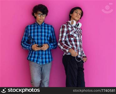 Arabic teenagers group portrait against a pink wall. High quality photo. Arabic teenagers group portrait against pink wall 