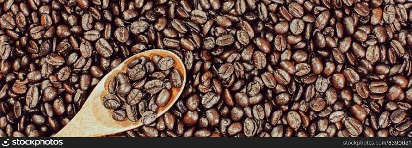 Arabica coffee beans roasted and wooden spoon,panoramic banner background