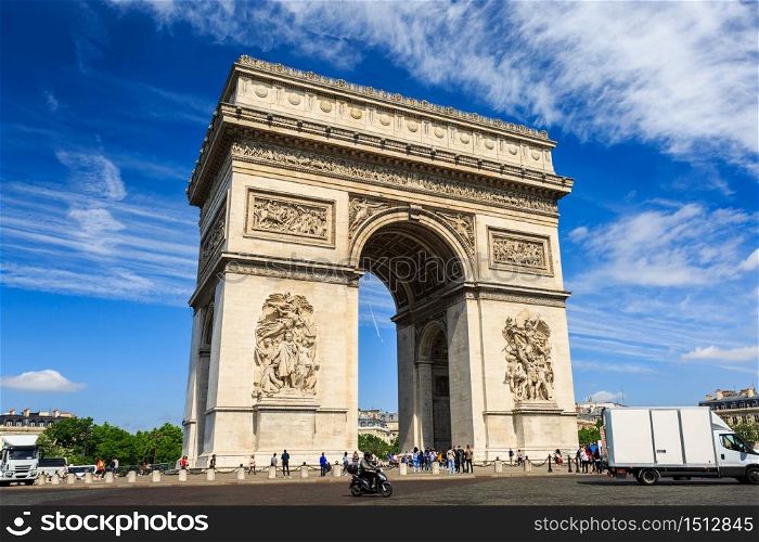 Arc de Triomphe on blue sky background in Paris, France.