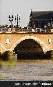 Arch bridge across a river, Pont De Pierre, St. Michel Basilica, Garonne River, Bordeaux, Aquitaine, France