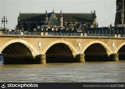 Arch bridge over a river, Pont De Pierre, St. Michel Basilica, Garonne River, Bordeaux, Aquitaine, France