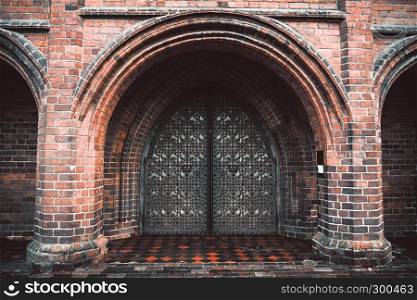 Arch entry door on red brick wall background