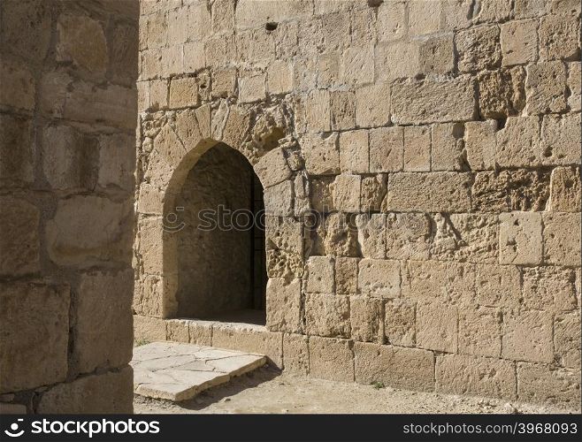 Arch window in old stone wall of medieval castle, horizontal image with copy space