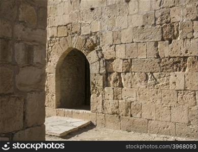 Arch window in old stone wall of medieval castle, horizontal image with copy space