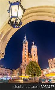 arch with lamp, night photo of the Mariak Church in the center o. arch with lamp, night photo of the Mariak Church in the center of Krakow, Poland