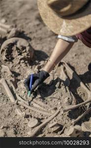 Archaeology - excavating ancient human remains with digging tool kit set at archaeological site. . Archaeology - Excavating part of an Ancient Human Skeleton with Digging Tool Kit