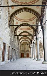 Arched courtyard corridor of the Blue Mosque ( Turkish: Sultan Ahmet Camii) in Istanbul, Turkey