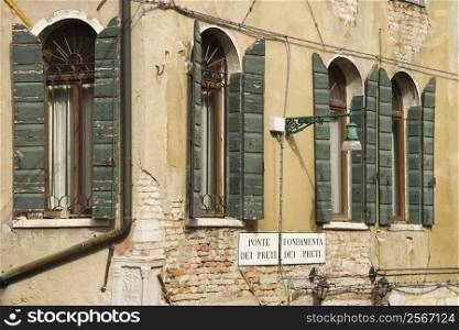 Arched windows with shutters in Venice, Italy.