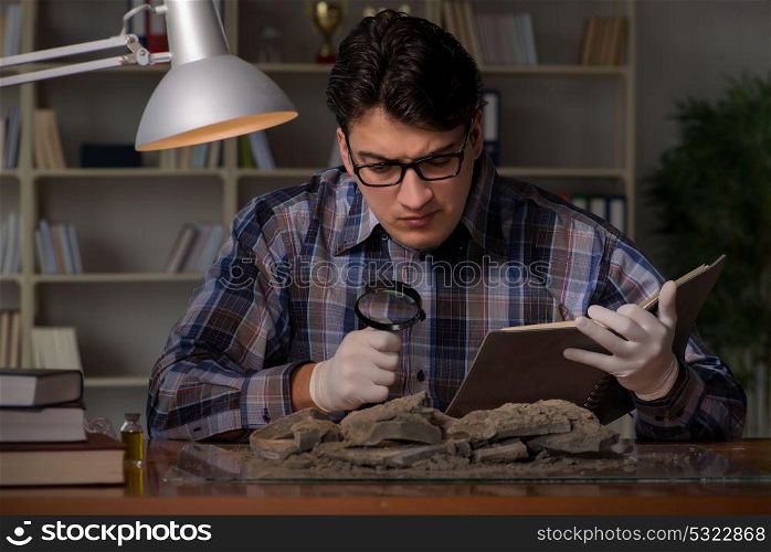 Archeologist working late night in office