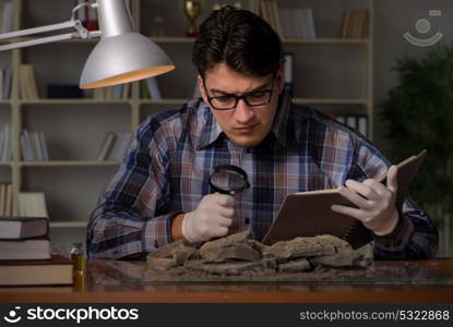 Archeologist working late night in office