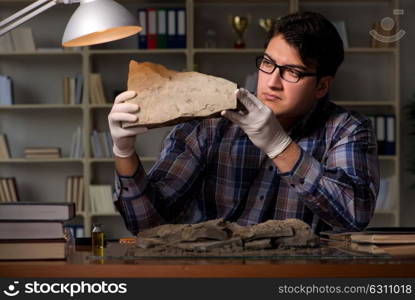 Archeologist working late night in office