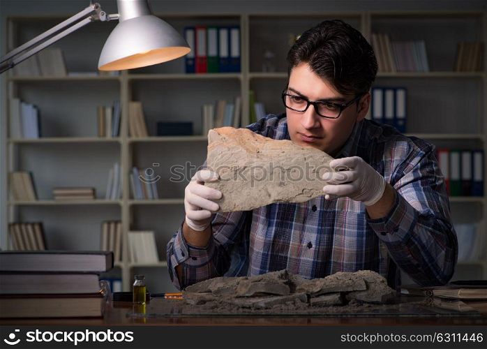 Archeologist working late night in office