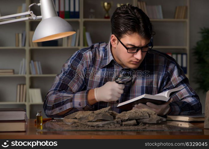 Archeologist working late night in office