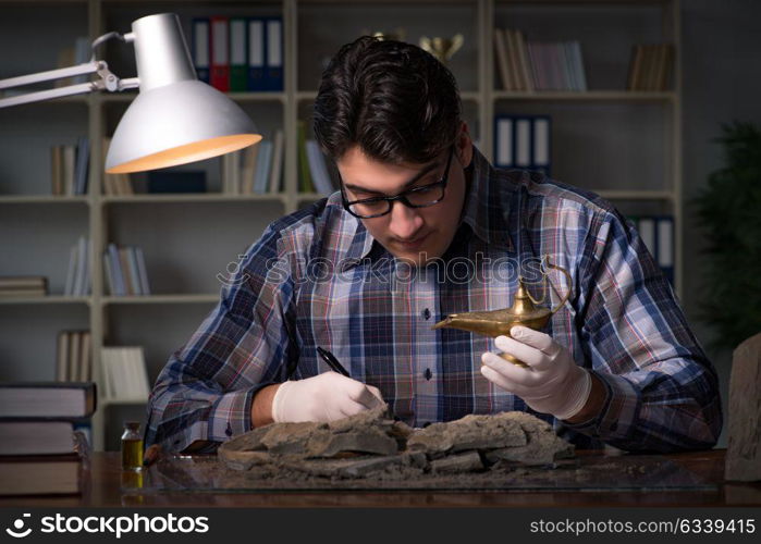 Archeologist working late night in office