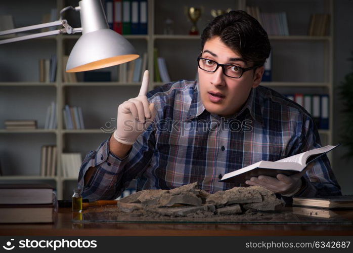 Archeologist working late night in office