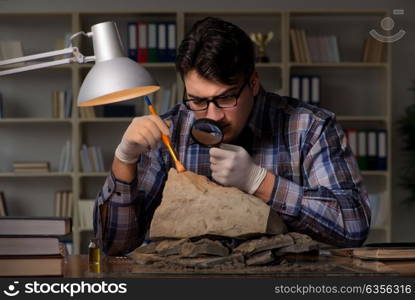 Archeologist working late night in office