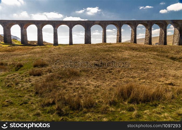 Arches against blue sky and cloud of the Ribblehead Viaduct, landscape. North Yorkshire, Europe, England, landscape
