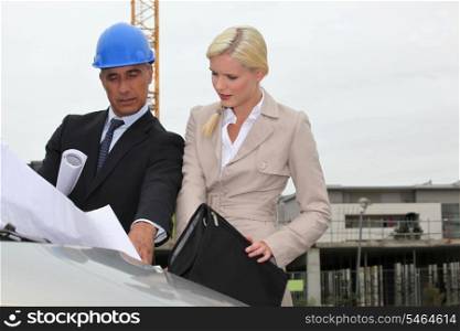 Architect and assistant visiting construction site