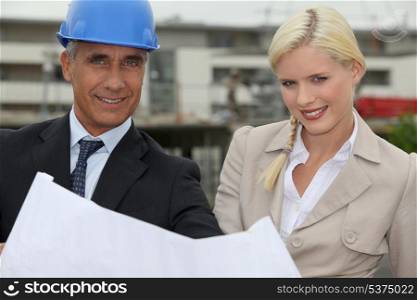 Architect and assistant working on-site