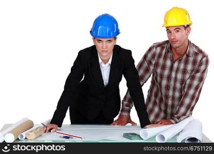 Architect and builder looking at plans