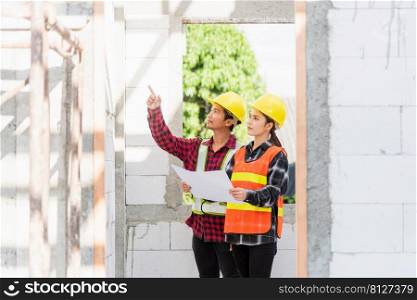Architect and client discussing the plan with blueprint of the building at construction site. Asian engineer foreman worker man and woman working talking and checking on draw paper to checking project