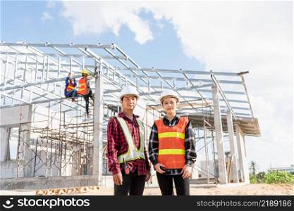 Architect and client standing at home building construction site. Portrait Asian engineer foreman worker man and woman in hardhat posing on building, Concept for team work