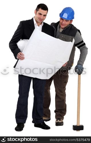 Architect and construction worker looking at plans