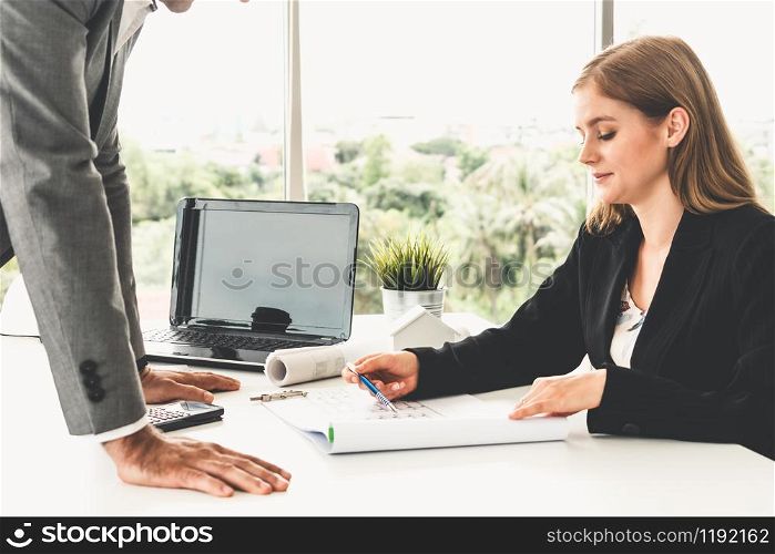 Architect and engineer working with construction drawing project on table in office. Architecture and engineering business concept.