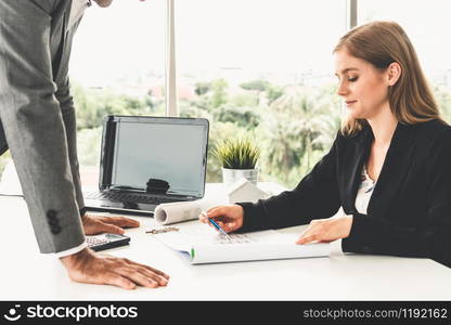 Architect and engineer working with construction drawing project on table in office. Architecture and engineering business concept.