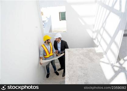 Architect and foreman meeting at construction site,Architect inspects the construction site,Construction project concept.