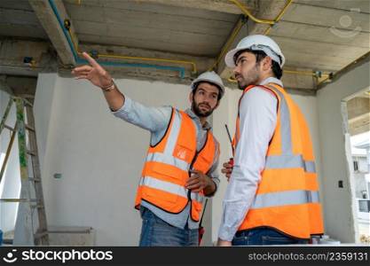 Architect and foreman meeting at construction site,Architect inspects the construction site,Construction project concept.