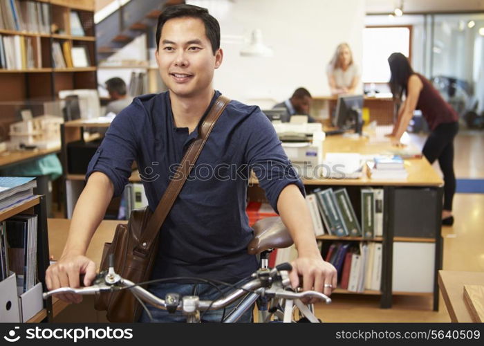 Architect Arrives At Work On Bike Pushing It Through Office