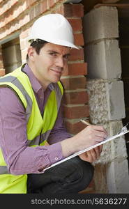 Architect Checking Insulation During House Construction