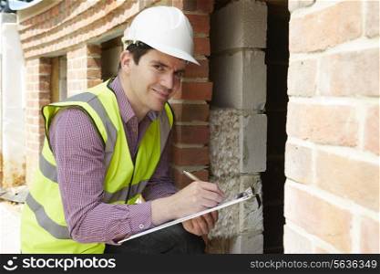 Architect Checking Insulation During House Construction