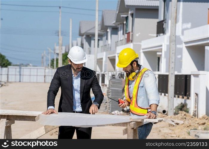 Architect concept,Architects and businessman working with blueprints at construction site,Construction project concept.