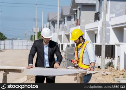 Architect concept,Architects and businessman working with blueprints at construction site,Construction project concept.