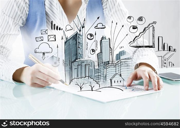 Architect designer at work. Close view of woman architect drawing modern construction project