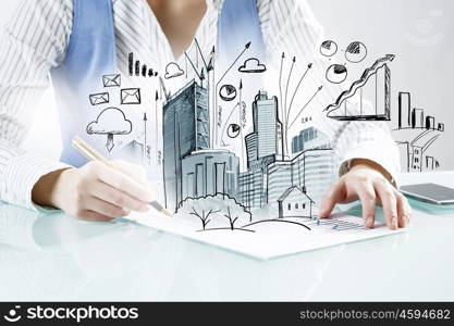 Architect designer at work. Close view of woman architect drawing modern construction project