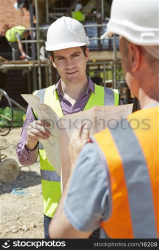 Architect Discussing Plans With Builder On Construction Site