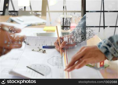 architect engineer interior designer team working discussing on house blueprint of real estate project in meeting. building construction teamwork concept
